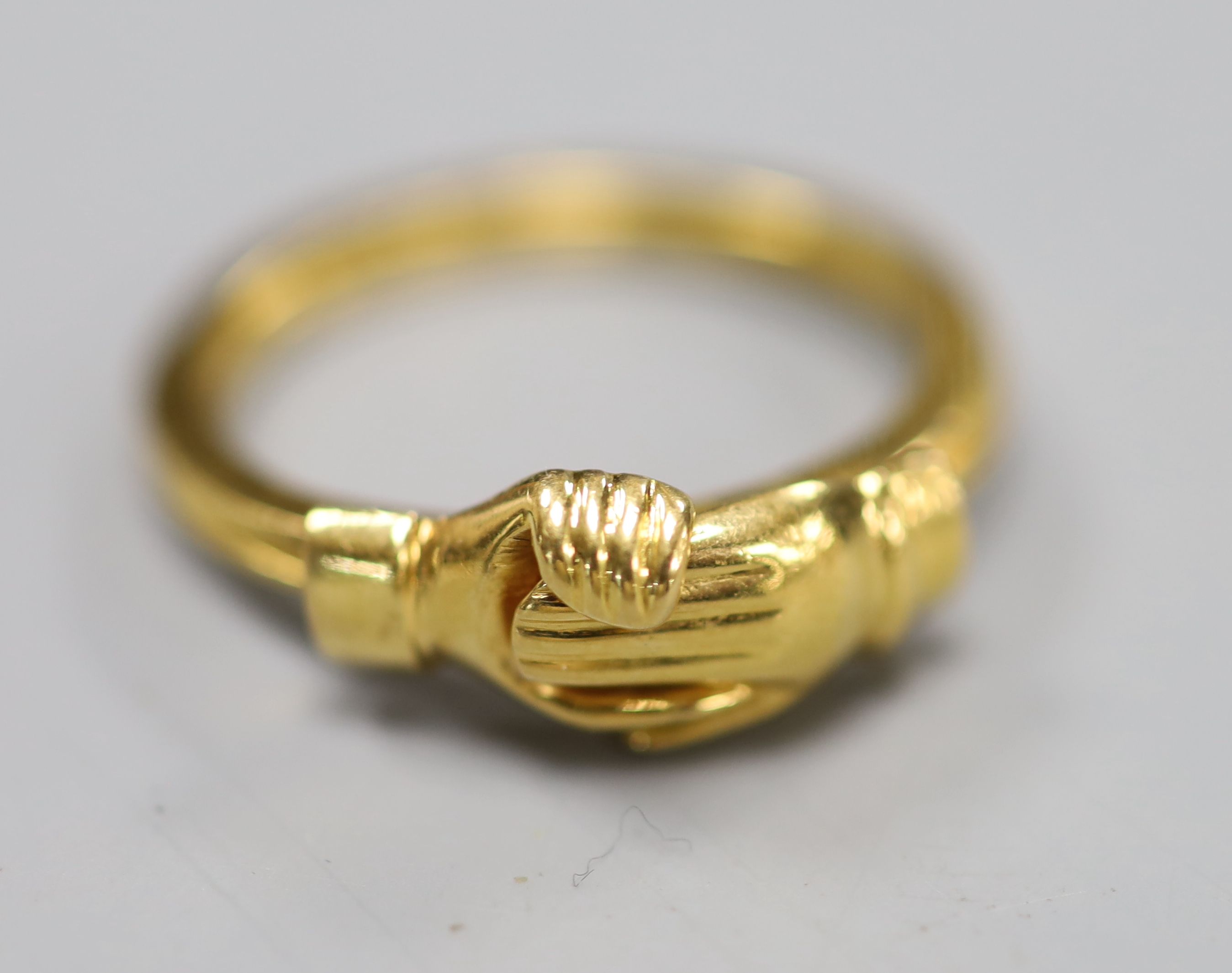 A yellow metal triple shank fede ring, opening to reveal a heart engraved with the letter M, size Q, 6.1 grams.